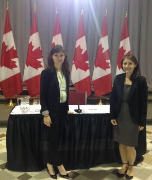 Claire Davis, Law’19, and Kate Withers, Law’17, stand before the table where Justice Malcolm Rowe sat while answering questions from MPs and senators in the University of Ottawa’s Tabaret Hall on Oct. 25.