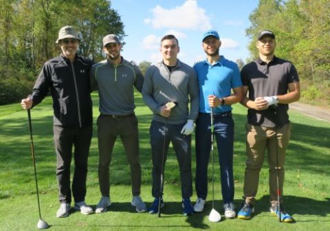 Dean Bill Flanagan on the green at the Loyalist Golf & Country Club with student golfers who participated in the ‘Out Drive the Dean’ competition during the Queen’s Law Fall Classic Charity Event.