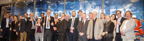 Dean Bill Flanagan (10th left) and alumni celebrate Queen’s Law in Edmonton at Rogers Place. (Photo by Grant Cree)