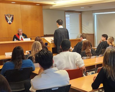 Presiding over the Grand Moot, Justice Graeme Mew of the Superior Court of Justice poses a question to mooter Kelvin Lau. 