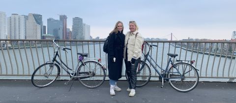 Two women on a bridge with bikes in Groningen