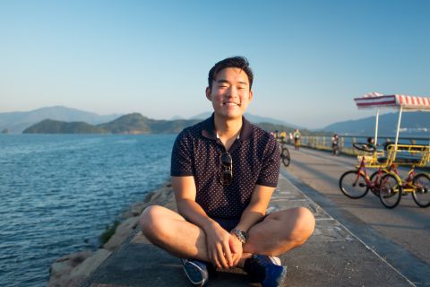 Student sitting on a pier in Hong Kong