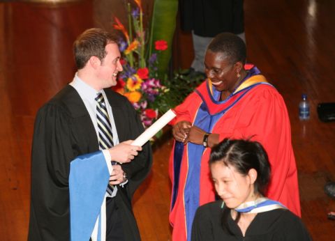 Professor Rosemary King greets graduating students before hooding them at Spring Convocation 1997.