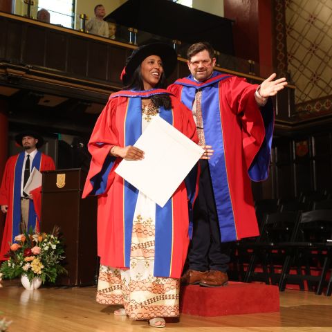 Hiwot Mekuanent receives her PhD in Law degree as she crosses the stage in Grant Hall at the Fall 2024 Convocation ceremony on Nov. 15. (Photo by Bernard Clark)