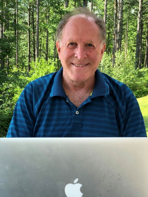 Professor Nick Bala works on a family law project using his laptop in his summer office.