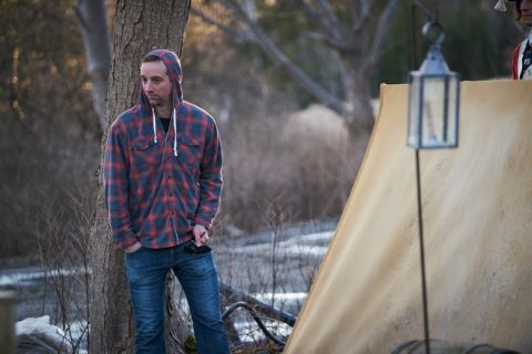 Alex Patrick, Law’10, President and Executive Producer of Take the Shot Productions Inc., watches his film crew on the set of the company’s popular Netflix series Frontier, starring Hollywood’s Jason Momoa and Newfoundland’s Allan Hawco, who’s also one of Patrick’s business partners. (Photo by Duncan DeYoung)