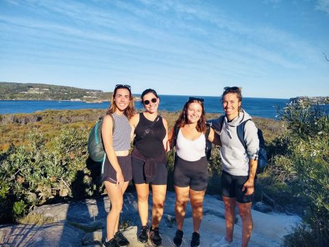 Four students on a rock ledge in Australia 