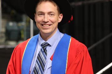 Ryan Minor, PhD’24, who received his doctoral degree from Queen’s on June 21, reflects on his time at Queen’s Law and explores arguments for and against Canada implementing a preferential tax treatment for intellectual property income that could spark a surge of innovation and productivity. (Photo by Bernard Clark)